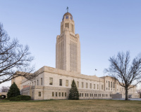 A photo of the Nebraska State Capitol.  The limestone structure, which draws upon a myriad of architectural traditions in its design, was designed by Bertram Goodhue and constructed between 1922 and 1932.  The Nebraska State Capitol, located in Lincoln, is a National Historic Landmark.  This photo © Capitolshots Photography/TwoFiftyFour Photos, LLC, ALL RIGHTS RESERVED.