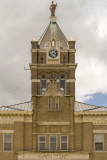 A photo of the clock tower of the Marion County Courthouse in Palmyra, Missouri.  The clock tower is topped by a statue of Lady Justice.  Marion County also has a courthouse in Hannibal, although Palmyra is the county seat.  The Palmyra courthouse was designed by William N. Bowman.  The Marion County Courthouse, a brick Romanesque Revival structure, was built in 1901.  This stock image Copyright Capitolshots Photography, ALL RIGHTS RESERVED.