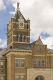 An image of the clock tower of the Marion County Courthouse in Palmyra, Missouri.  The clock tower is topped by a statue of Lady Justice.  Marion County also has a courthouse in Hannibal, although Palmyra is the county seat.  The Palmyra courthouse was designed by William N. Bowman.  The Marion County Courthouse, a brick Romanesque Revival structure, was built in 1901.  This stock photo Copyright Capitolshots Photography, ALL RIGHTS RESERVED.